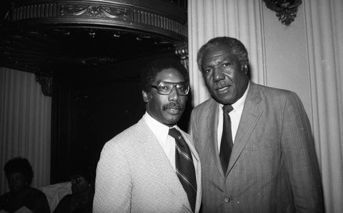 Edward Vincent posing with an unidentified man during a fundraising event for the Dunbar Hotel, Los Angeles, 1983