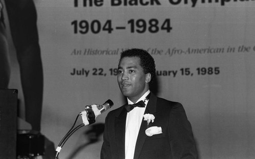 Speaker addressing an audience at the California African American Museum exhibit "The Black Olympians," Los Angeles, 1985