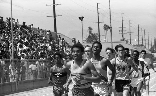 Spectators watching runners in a pack compete, Los Angeles