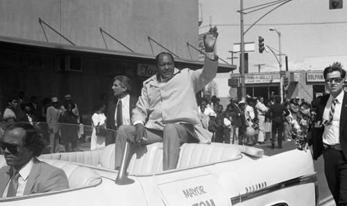 Tom Bradley waving to the crowd during the South Central Los Angeles Easter Parade, Los Angeles, 1983