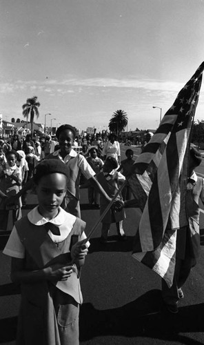 Girls in uniform marching in a parade celebrating the birthday of Dr. Martin Luther King, Jr., Los Angeles, ca. 1987