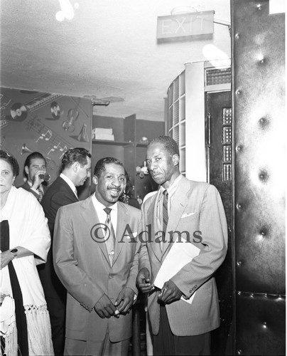 Erroll Garner posing with an unidentified man at the Tiffany Club, Los Angeles, 1954