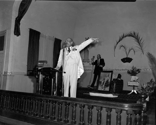 Bishop Charles Manuel "Sweet Daddy" Grace speaking from the pulpit , Los Angeles, ca. 1950