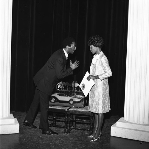 Shirley Chisholm talking with an unidentified man at the Wilshire Ebell Theatre, Los Angeles, 1970