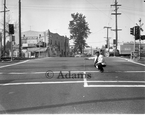 Man swatting in street, Los Angels, 1964