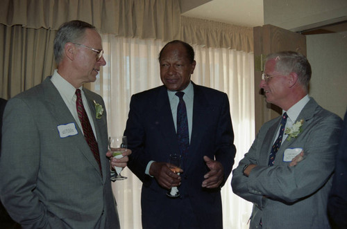 Tom Bradley talking with two men, Los Angeles, 1992