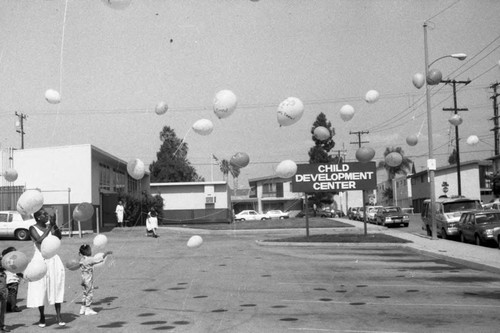 Child Development Center children and adults releasing balloons, Los Angeles, 1987