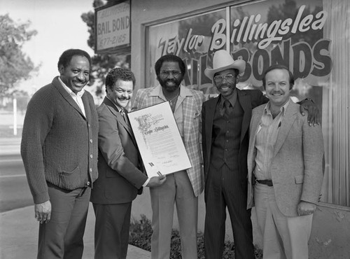 Taylor Billingslea posing with Bob Farrell and others, Los Angeles, 1983