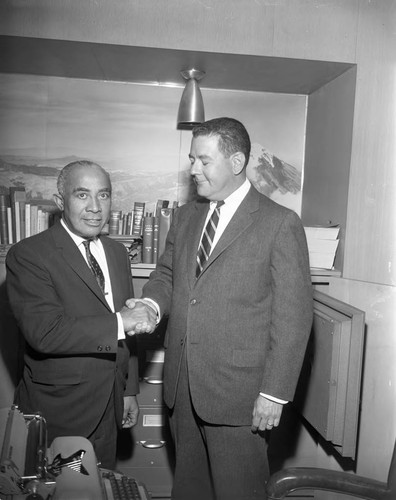 Lindsay shakes hands with man, Los Angeles, 1963