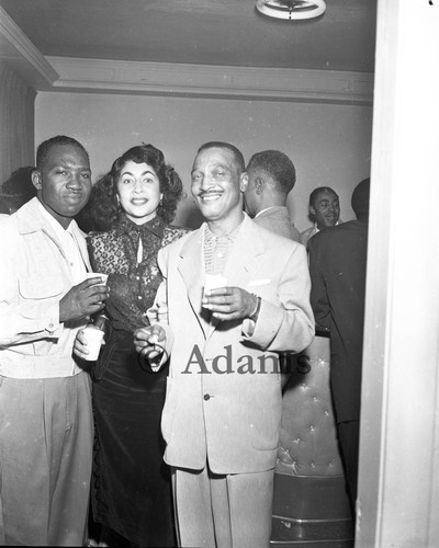 Men and woman in a crowded room, Los Angeles, 1954