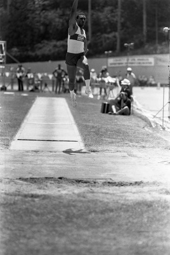 Athlete completing a long jump, Los Angeles, 1982