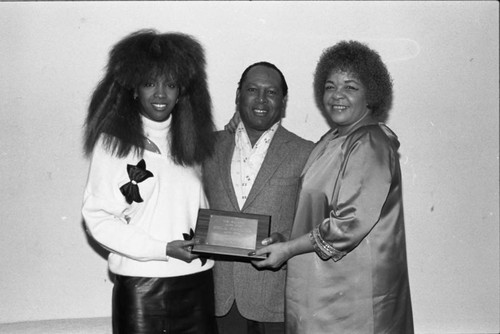 Me'lisa Morgan and Zola Taylor holding an award at the Pied Piper nightclub, Los Angeles, 1986