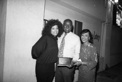 Nate Holden posing with Jackée Harry and Reve Gipson at the Pied Piper nightclub, Los Angeles, 1987