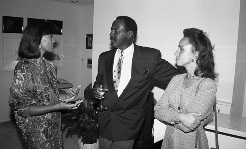 Claudette Roche and Richard Roundtree talking to Drew staff at the Friends of Drew Society launch party, Los Angeles, 1993