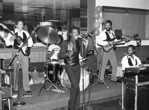 Vernon Garrett and his band performing on a stage during a Daysman Social and Charity Club event, Los Angeles, 1984