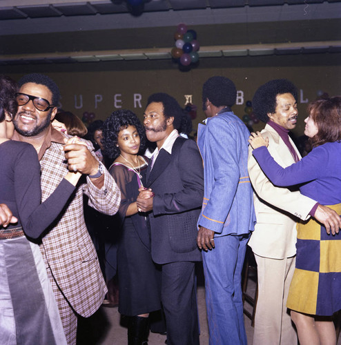 Herb and Connie Thompson dancing together at their Super Bowl party, Los Angeles, 1977