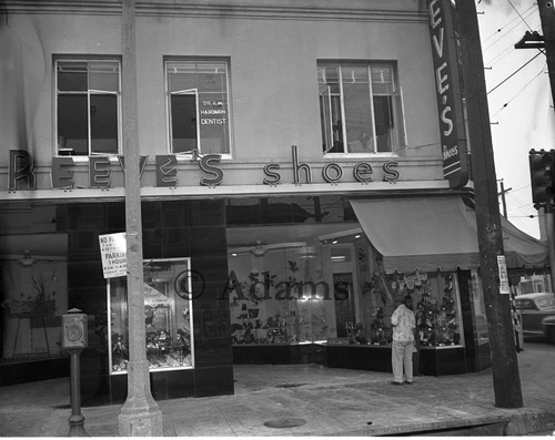 Men stands outside Reeve's Shoes, Los Angeles, 1955