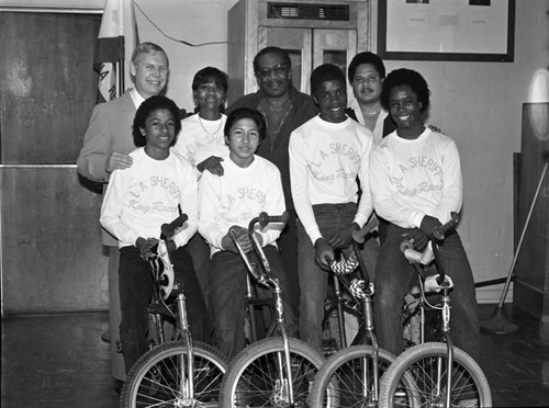 L.A. Sheriff King Racers Bicycle Club members and sponsors posing at a breakfast meeting, Los Angeles, 1983