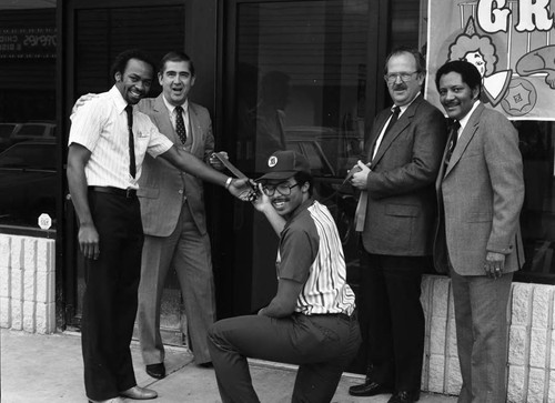 Baskin Robbins ribbon cutting ceremony participants posing together, Los Angeles, 1983