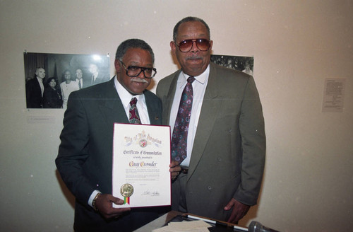 Guy Crowder receiving a commendation during his exhibit opening, Los Angeles, 1993