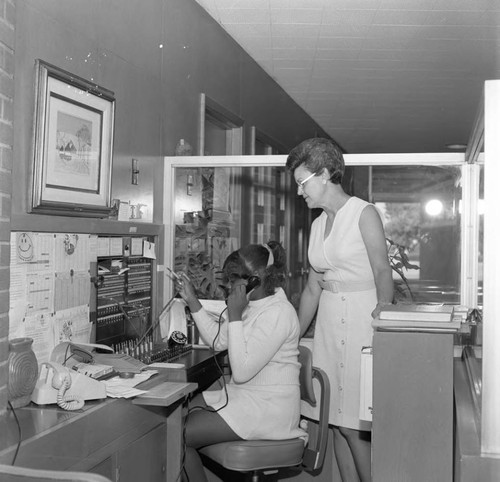 Young woman operating a switchboard at Compton College, Los Angeles, ca. 1972