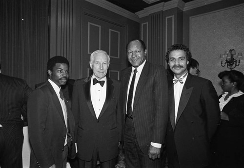 Tom Bradley poses with LeVar Burton, James Zumberge, and Ron Glass at a USC Ebonics Support Group event, Los Angeles, 1983