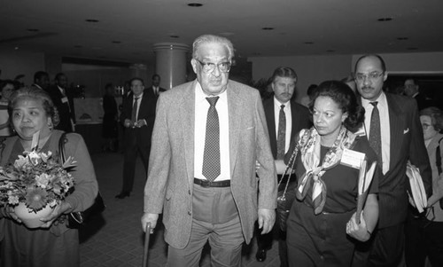 Supreme Court Justice Thurgood Marshall walking through a hallway at an ABA event, Los Angeles, 1990