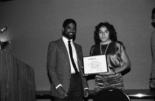 Cities Community Involvement Team participants holding an award, Los Angeles, 1985