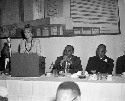 Woman at podium, Los Angeles, 1964