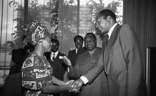 Tom Bradley greeting a women in traditional dress at an International Club of Los Angeles event, Los Angeles, 1981