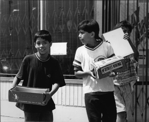 Boys carrying shoe boxes, Los Angeles, ca. 1992