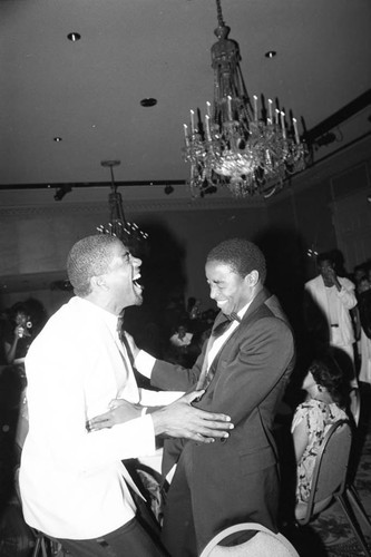 Isiah Thomas sharing a laugh with Magic Johnson during at a party, Los Angeles, 1985