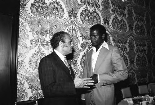 Benjamin Hooks and Sidney Poitier talking at a dinner preceding the 17th Annual NAACP Image Awards, Los Angeles, 1984