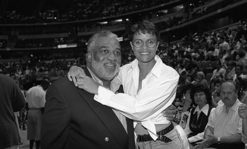 Couple posing together during "A Midsummer Night's Magic" basketball game, Anaheim, 1995