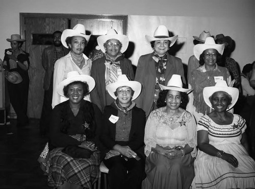 Guests posing together at the National Association of Media Women's western hoedown, Los Angeles, 1983