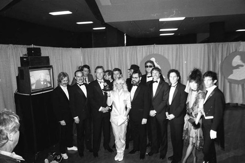 Kim Carnes posing with others at the 26th Annual Grammy Awards, Los Angeles, 1984