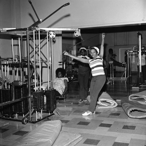 Woman exercising at the Compton College gym, Compton, 1972