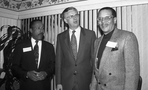 Reginald A. Dunn and James Hahn posing together during an event at a private home, Los Angeles, 1996