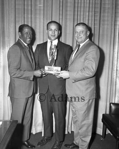 Men holding award, Los Angeles, 1969