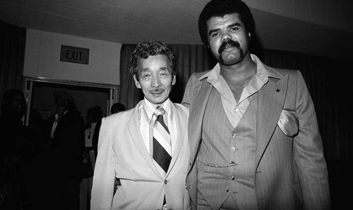 Two unidentified men posing together at an event, Los Angeles, 1977