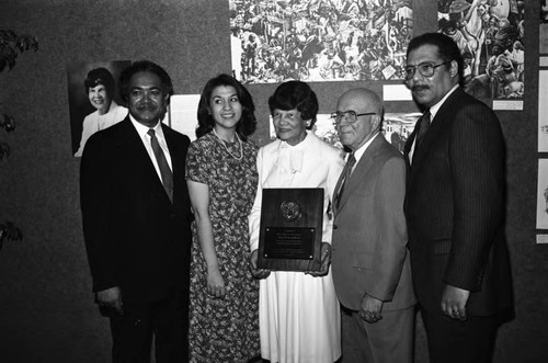 Miriam Matthews holding an award while posing with others, Los Angeles, 1984