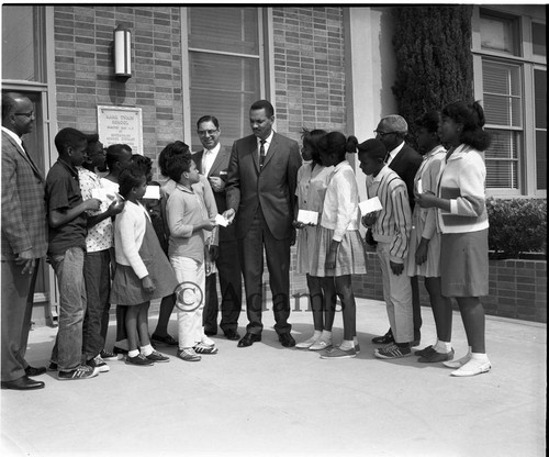 Greeting school children, Los Angeles, 1964