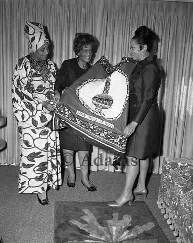 Examining fabric, Los Angeles, 1969