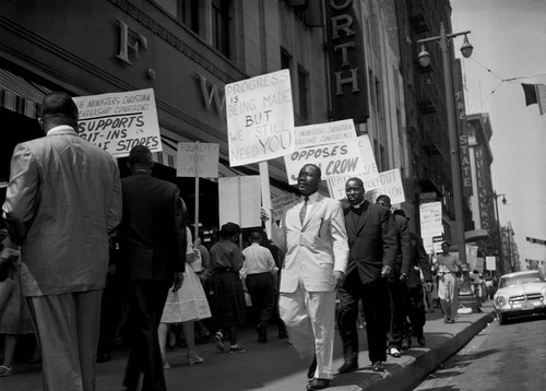 Dr. Martin Luther King Jr. picketing in front of a Woolworth store, Los Angeles, 1960