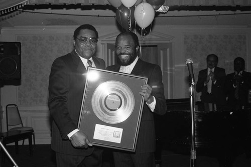 Bob G. Jones receiving a gold record during a Black Public Relations Society of Southern California event, Los Angeles, 1986