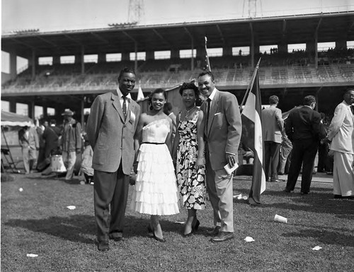 Nat King Cole posing with Joe Adams and guests at the 9th Cavalcade of Jazz, Los Angeles, 1953