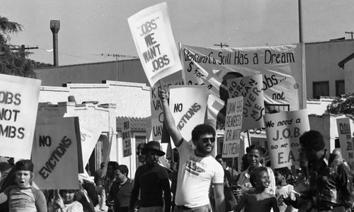 Crowd marching in a parade during a celebration of Dr. Martin Luther King's birthday, Los Angeles, ca. 1987