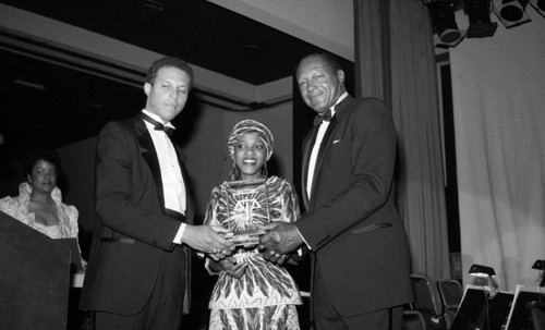 Mpho Tutu holding an NAACP award with Douglas Dollarhide and Tom Bradley, Los Angeles, 1985