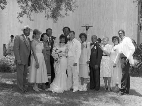 McDonald and Aubrey wedding party members posing together, Los Angeles, 1985