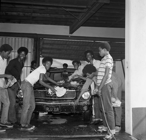 Young men washing a car, Compton, 1971